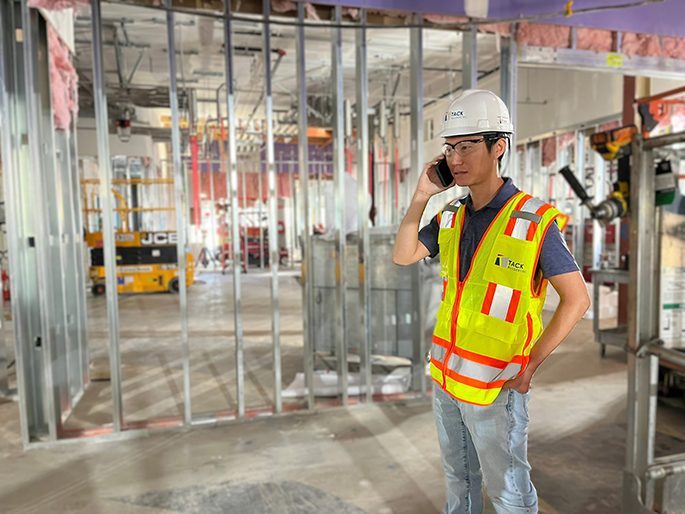 Design-Build Construction Team in Safety Vests Onsite Communication